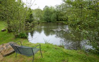 Mill Meadow Relaxing bench next to stream